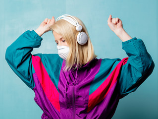 woman in 90s clothes and face mask with headphones