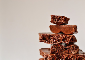 Chocolate on a white background, isolated. Porous Chocolate Texture