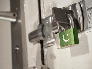 A bolted door secured by a padlock with the national flag of Pakistan on it.(series)