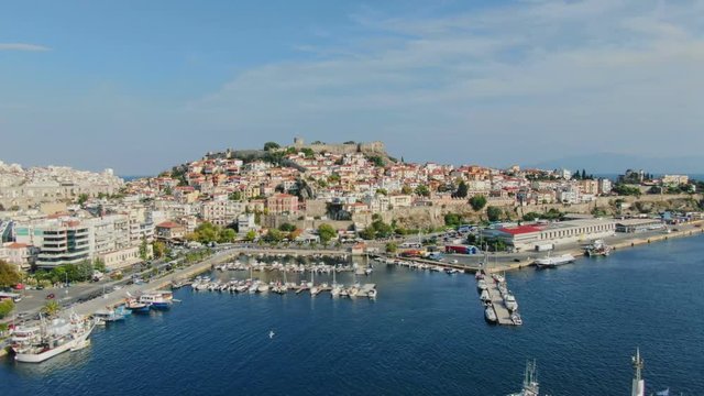 Aerial drone view above Greek town Kavala. Flying top view of old city and sea port of famous UNESCO world heritage historic monument from Greece medieval roman empire ages.