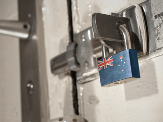 A bolted door secured by a padlock with the national flag of Victoria on it.(series)