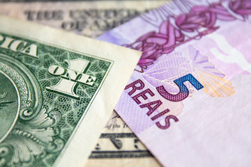US dollar bill and Brazilian reais banknotes, business finance exchange market