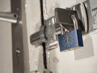 A bolted door secured by a padlock with the national flag of Indiana on it.(series)