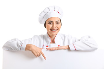 Portrait of female chef with blank poster on white background