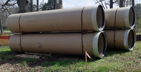 Stacked pipes for culvert construction project.