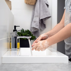 Coronavirus pandemic prevention wash hands with soap warm water