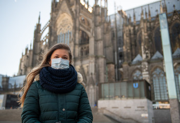 Fototapeta na wymiar German girl wearing virus mask