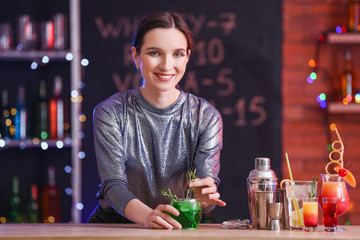 Beautiful female bartender in pub