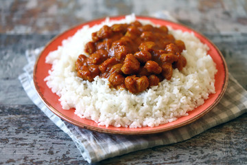 Vegan curry rice on a plate. White rice with curry with soy meat. Vegan lunch. Healthy food. Diet.