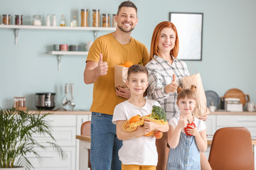 Family with fresh products from market in kitchen