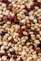 mix of quinoa grains on white acrylic background