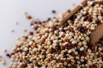 mix of quinoa grains on white acrylic background