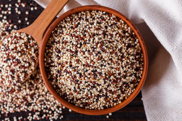 mix of quinoa grains on dark wooden rustic background