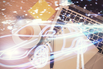 Auto pilot hologram drawing over computer on the desktop background. Top view. Double exposure. Tech concept.