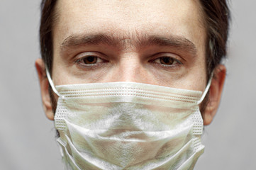sick man in a medical mask. sad eyes close up