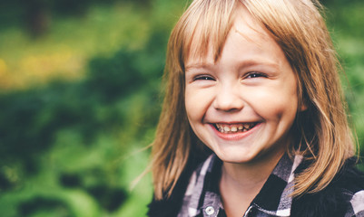 Fototapeta premium Portrait of a happy smiling child girl. Laughing child.