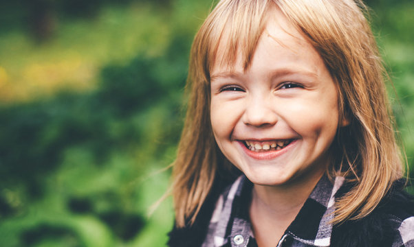 Portrait of a happy smiling child girl. Laughing child.