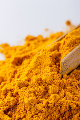 natural turmeric powder on white acrylic background