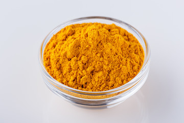 natural turmeric powder on white acrylic background