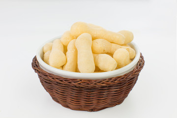 Traditional Brazilian starch biscuit called biscoito de polvilho in a basket isolated in white background