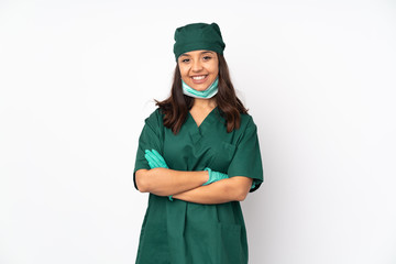 Surgeon woman in green uniform isolated on white background keeping the arms crossed in frontal position