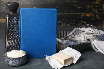 Cook book with products on dark background