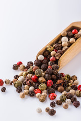 mix of peppercorns on white acrylic background