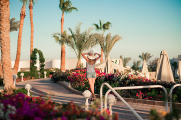 woman traveler posing with raising arms relaxing on viewpoint at the sea. Sexy tan perfect fit body...