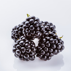 juicy blackberries on a white acrylic background