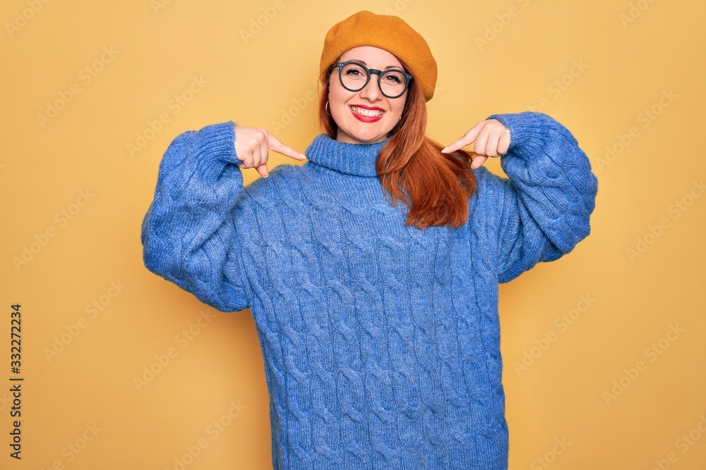 Sticker young beautiful redhead woman wearing french beret and glasses over yellow background looking confid