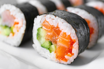 Plate with tasty sushi rolls, closeup