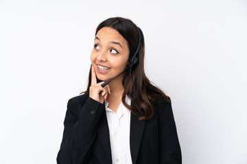 Young telemarketer woman isolated on white background thinking an idea while looking up