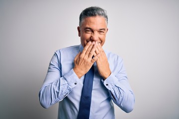 Middle age handsome grey-haired business man wearing elegant shirt and tie laughing and embarrassed...