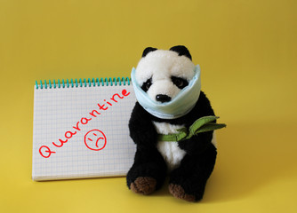 Soft toy panda in medical mask on a yellow background. Schools and kindergartens are under quarantine. Home schooling. Quarantine sign.