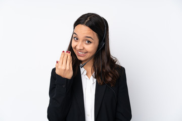 Young telemarketer woman isolated on white background inviting to come with hand. Happy that you came