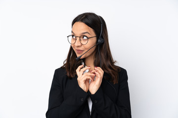 Young telemarketer woman isolated on white background scheming something