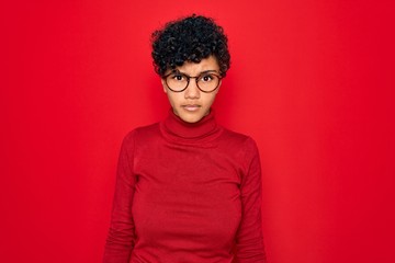 Fototapeta na wymiar Young beautiful african american afro woman wearing turtleneck sweater and glasses skeptic and nervous, frowning upset because of problem. Negative person.