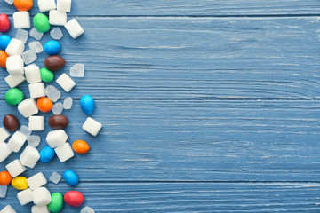 Sweet sugar and candies on wooden background