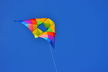 A colorful kite flying in the blue sky
