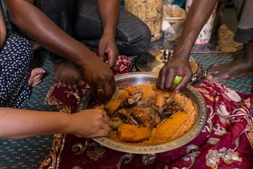People Eating Traditional Mauritanian Meal with Hands - obrazy, fototapety, plakaty