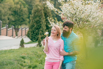 Couple in live walking in the spring Park and enjoying the beautiful spring blossom nature.
