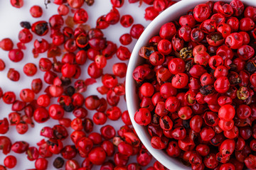 fragrant pink peppercorns on white acrylic background