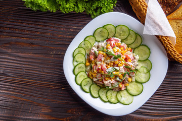 Fresh salad of vegetables and meat on wooden rustic background