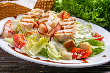 Caesar salad on dark wooden rustic background