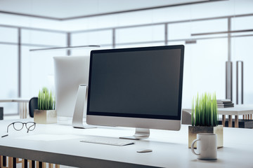 Coworking office and computer with blank screen