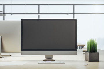Designer desktop with empty black computer screen