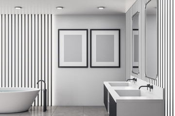 Fototapeta na wymiar Bathroom interior with white bath and two poster on wall.