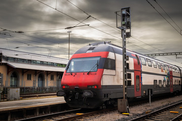 Fototapeta premium Red train on a train station in Konstanz, town in Germany