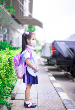 Thai Girl Student Wearing A Mask Against Dusk And Virus Before Going To School