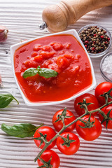 juicy canned tomatoes on wooden rustic background